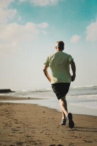 Senior man running on beach
