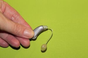 Hand holding hearing aid