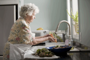 Senior woman washing veggies