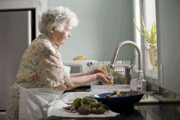 Senior woman washing veggies