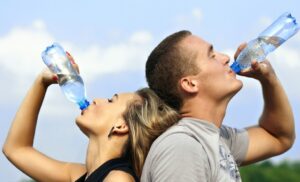Young couple drinking bottled water together