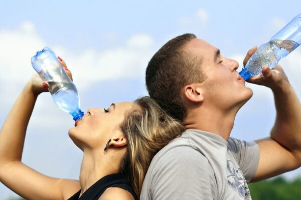 Young couple drinking bottled water together