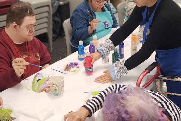 Taoran Xie guiding clients with artwork