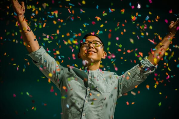 happy man throwing confetti